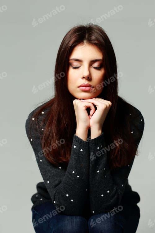 Preview: Portrait of a young pensive woman with closed eyes