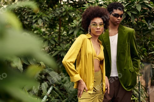 Preview: Young couple embraces love in a vibrant greenhouse surrounded by lush greenery and plants