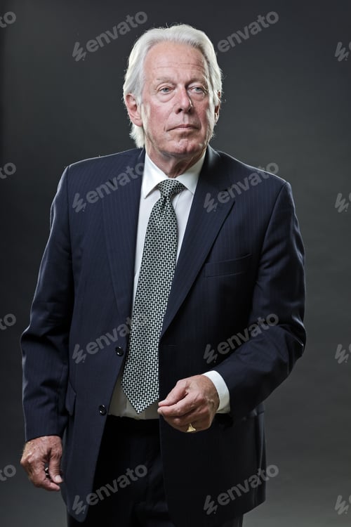 Preview: Studio Portrait Of Serious Senior Business Man In Blue Suit.