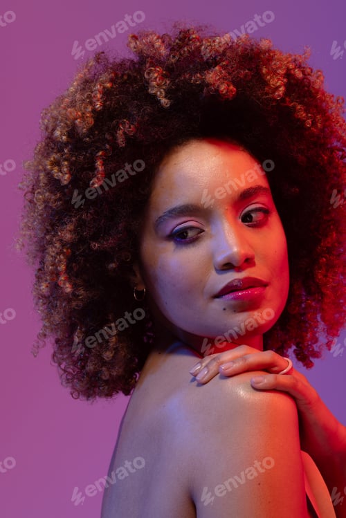 Preview: Biracial woman with curly hair with hand on shoulder on purple background