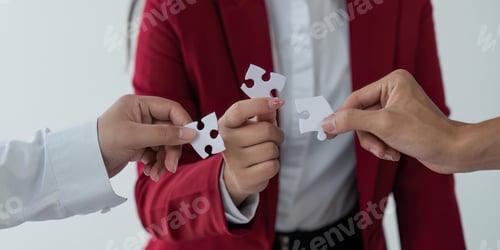 Preview: Concept of teamwork and partnership. Hands join puzzle pieces in the office. business people