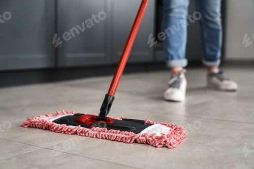 Preview: Close up of caucasian woman mopping the floor at home