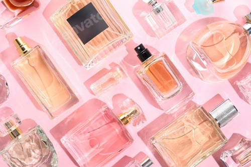 Preview: Bottles of various perfumes on pink background, flat lay