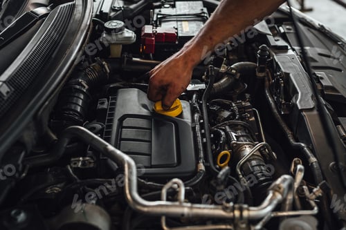 Preview: Auto mechanic working on a car engine, technical car inspection in service