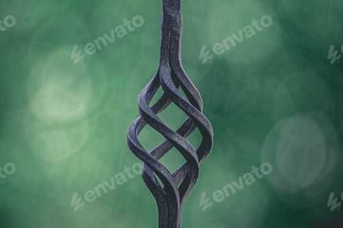 Preview: Close Up of Intricate Metal Spiral Against Green