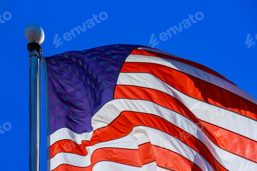 Preview: Close up of American flag waving on flagpole
