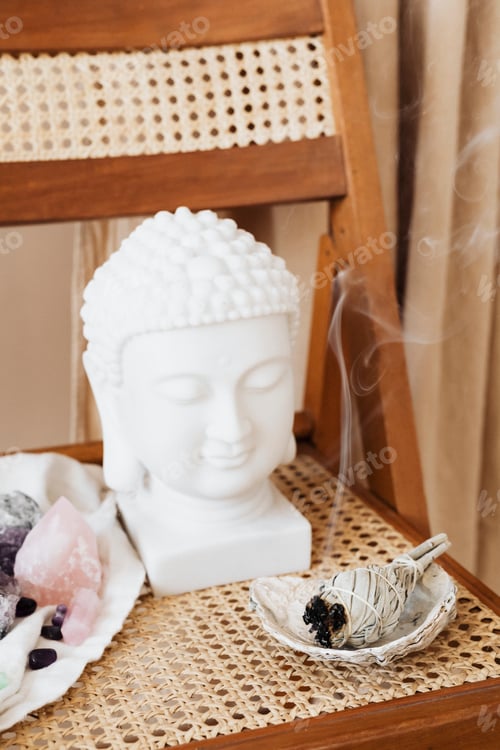 Preview: Buddha head statue by a burning sage smudge cleansing the house
