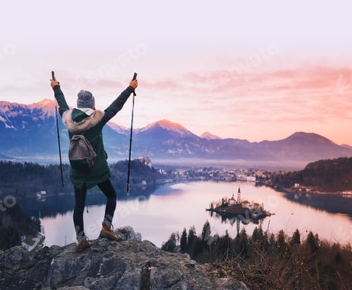 Preview: Traveling young woman looking on sunset on Bled Lake, Slovenia, Europe