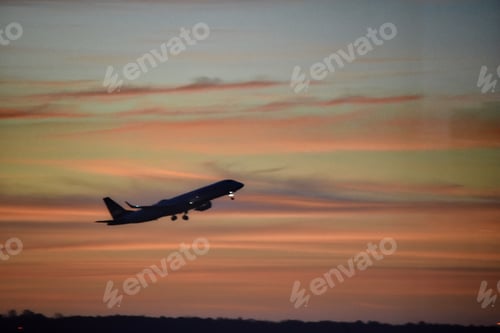 Preview: Plane taking off at sunset or sunrise