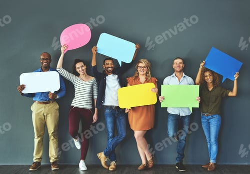 Preview: Studio shot of a diverse group of people holding up speech bubbles against a gray background