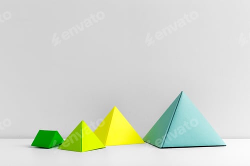 Preview: Colorful geometric shapes arranged on a clean surface against a plain wall