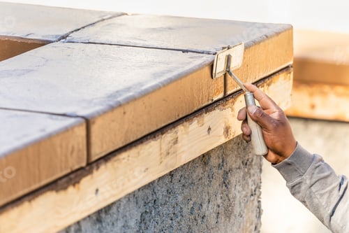 Preview: Construction Worker Using Hand Groover On Wet Cement Forming Coping Around New Pool