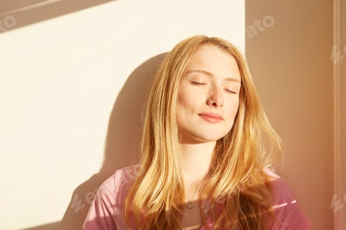 Preview: Portrait of young woman, outdoors, in sunlight, eyes closed