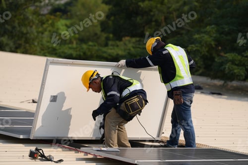 Preview: Engineer installing solar cell panels on roof.
