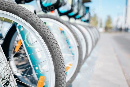 Preview: Bicycles for rent. Vehicles parked in a row, close-up of bicycle wheels outdoors