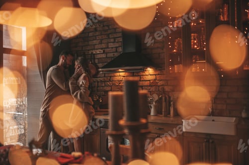 Preview: Candid authentic happy married couple spending time together at wooden lodge Xmas decorated