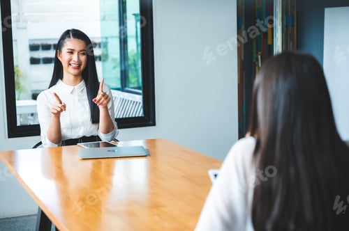 Preview: two people talking on table and keep distance, social distancing concept