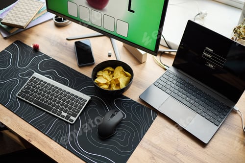 Preview: Modern Workspace Featuring Laptop and Desktop Computer with Potato Chips
