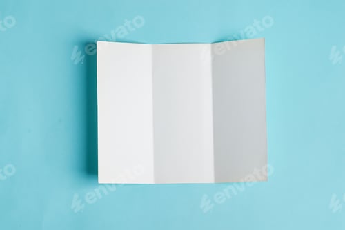Preview: Minimal trifold brochure template above blue background with shadows