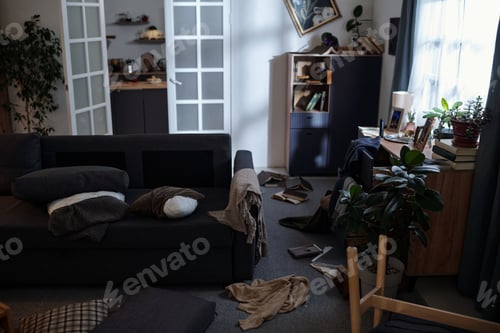 Preview: Messy Living Room Interior Showing Books Scattered and Furniture Disarranged