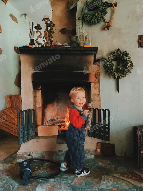 Preview: Toddler Plays near Fireplace Inside Stone Home