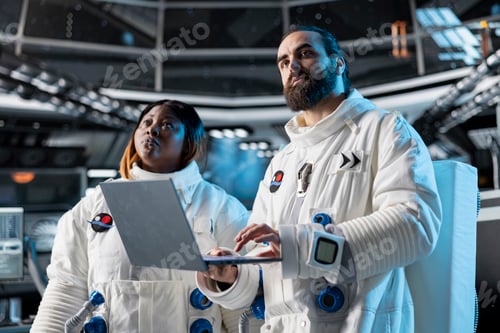 Preview: Team of astronauts in spacecraft using laptop to run telemetry data analysis