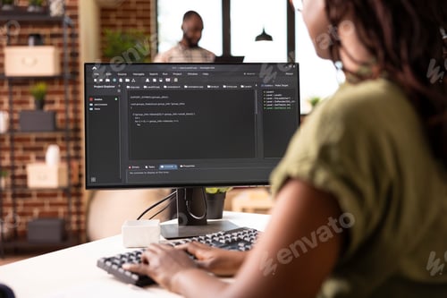 Preview: Female software developer typing code on computer