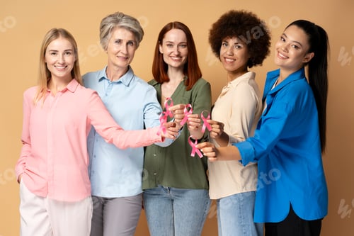 Preview: Women holding pink ribbon isolated on background. Breast cancer awareness month concept