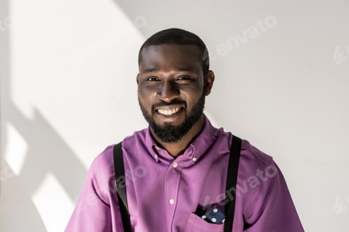 Preview: portrait of smiling african american handsome man looking at camera on grey background