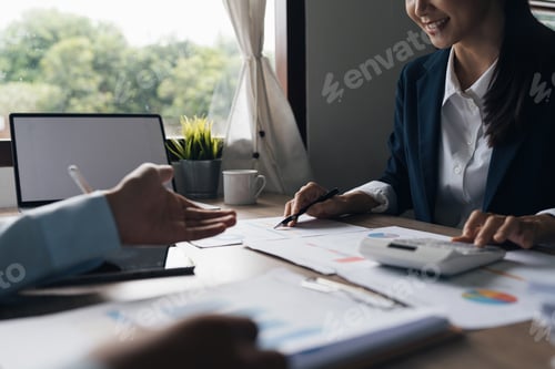 Preview: Business team using calculator to calculate the company's financial results and budget. Account