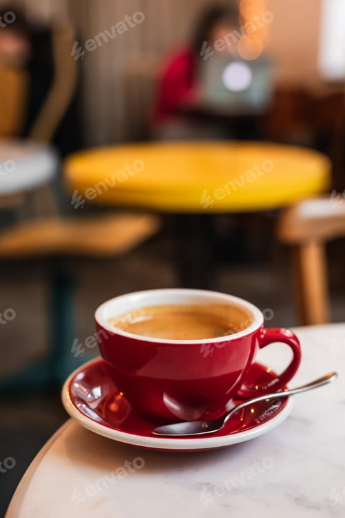 Preview: Cup of black coffee on the edge of a marble table in a cafe coffee-shop with copy space