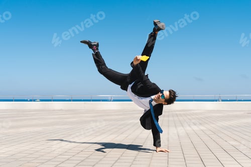 Preview: Flexible and cool businessman doing acrobatic trick