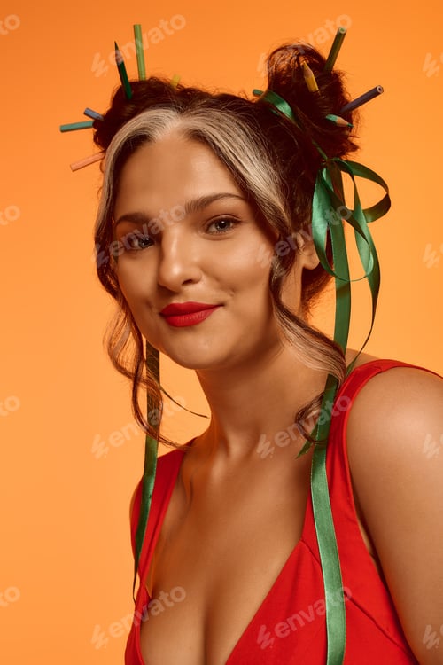 Preview: Young woman with Waardenburg syndrome flaunts a vibrant style on an orange backdrop