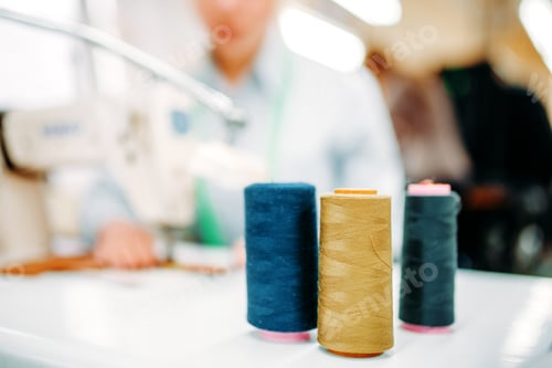 Preview: Colorful threads on spools closeup, dressmaking