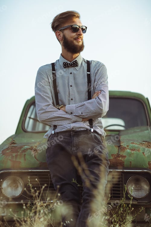 Preview: Young handsome stylish man, wearing shirt and bow-tie with old c