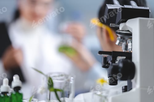 Preview: Pharmaceutical woman worker in protective clothing operating production line in sterile environment