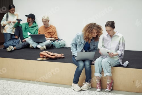Preview: Two young girls in casualwear preparing home assignment or school project