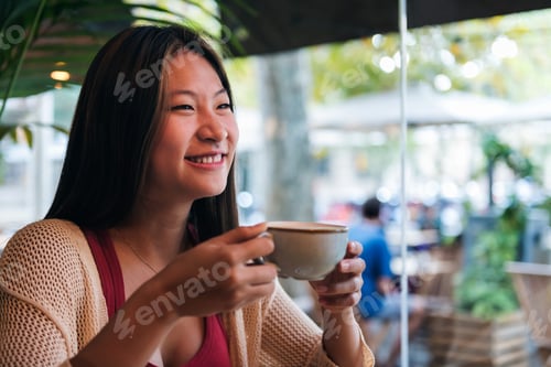 Preview: asian woman drinking coffee in a coffee shop
