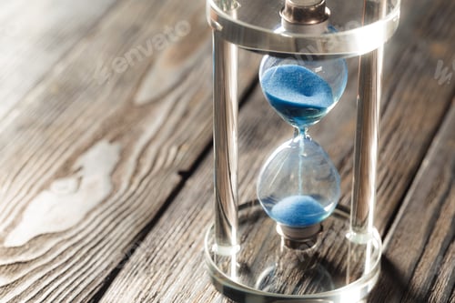 Preview: Modern hourglass on wooden background
