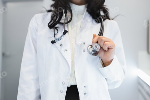 Preview: Medical Professional Holding Stethoscope in Doctor's Office