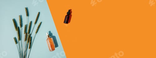 Preview: Face serum bottles on blue and orange backgrounds.