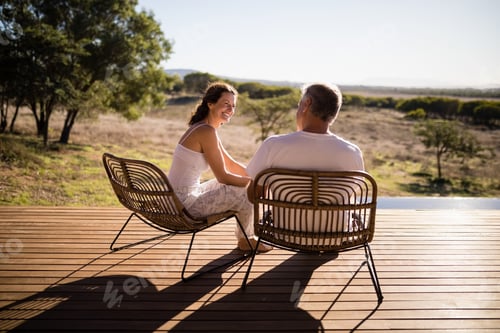 Preview: Senior couple sitting on chairs at the resort