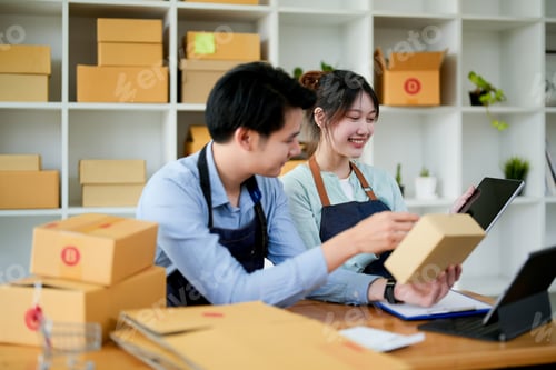 Preview: startup small business owner working with tablet at workplace. freelance man and woman seller check