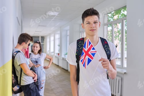 Preview: Teenager student with British flag, school corridor group of students background