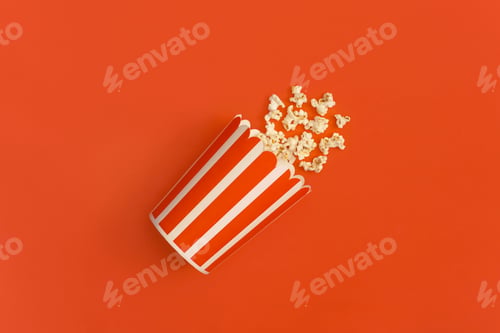 Preview: Popcorn in striped bucket isolated on red background