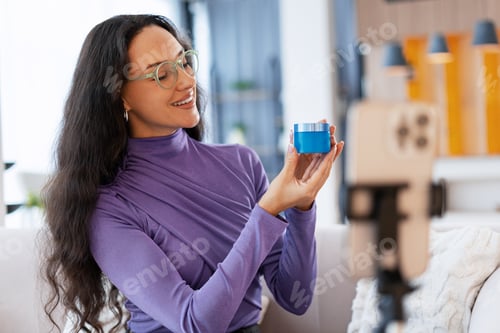 Preview: Woman creating beauty content reviewing cosmetic product