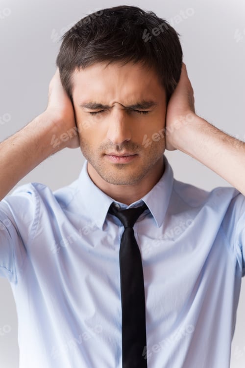 Man Covers Ears in Distress Wearing Dress Shirt