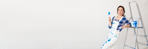 Preview: Banner repair, renovation and new home concept - young woman doing redecoration over white wall copy