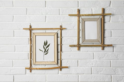 Preview: Stylish bamboo frames hanging on white brick wall