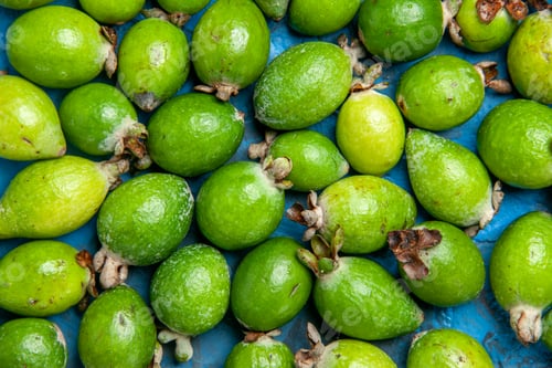 Preview: Top view of fresh natural green feijoas small vitamin bomb on blue background